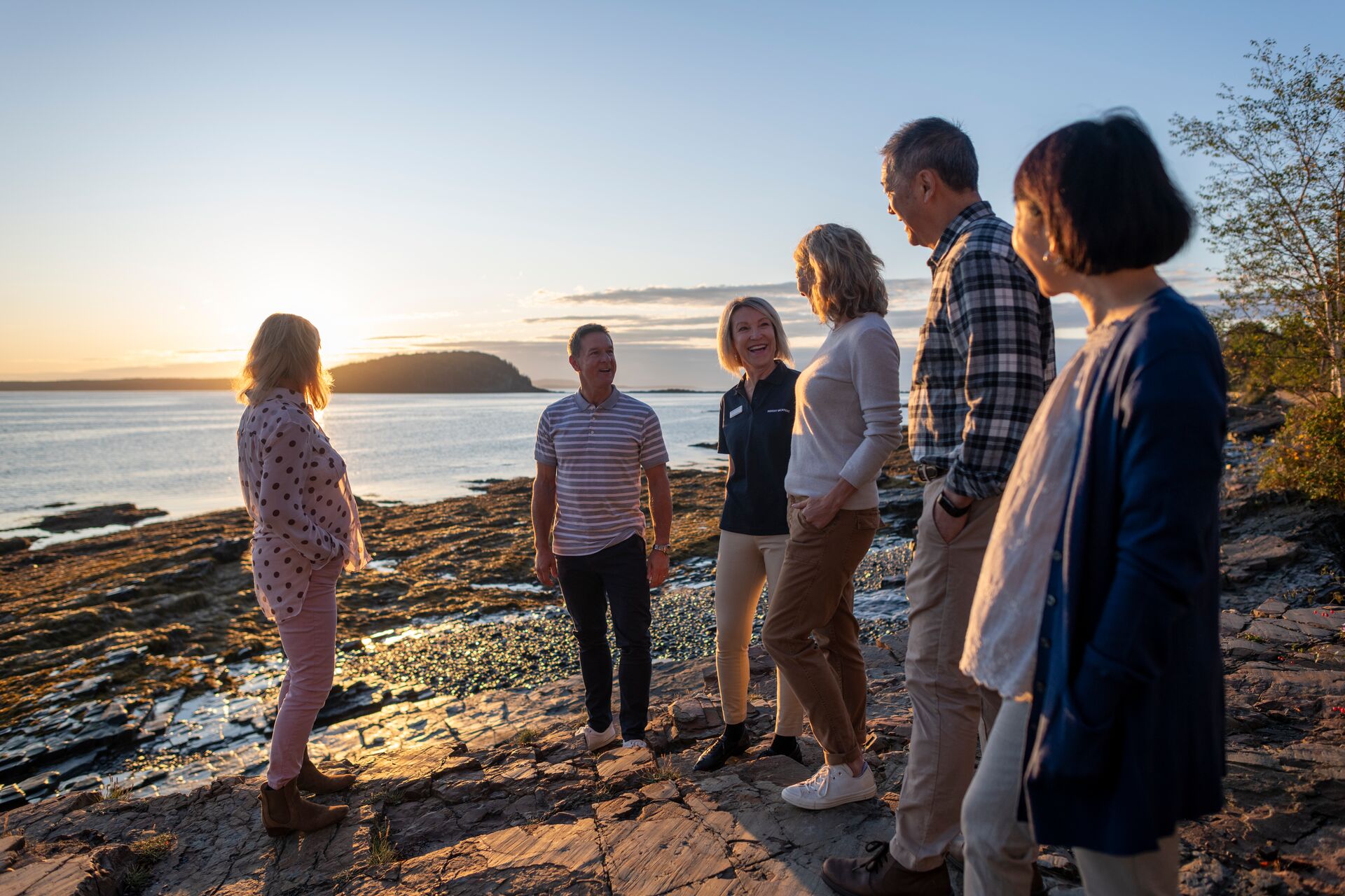 Travel director talking to tourists on Shore Path Bar Harbour in Maine, USA