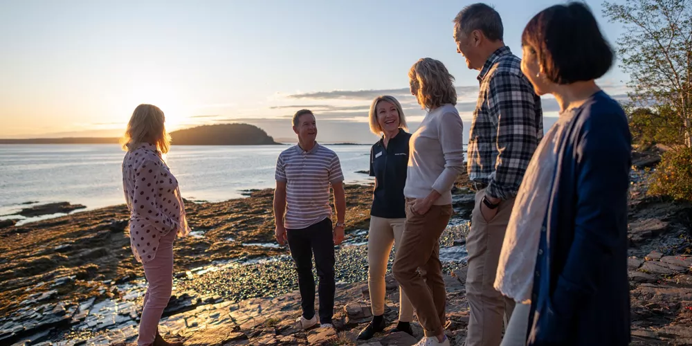 Travel director talking to tourists on Shore Path Bar Harbour in Maine, USA