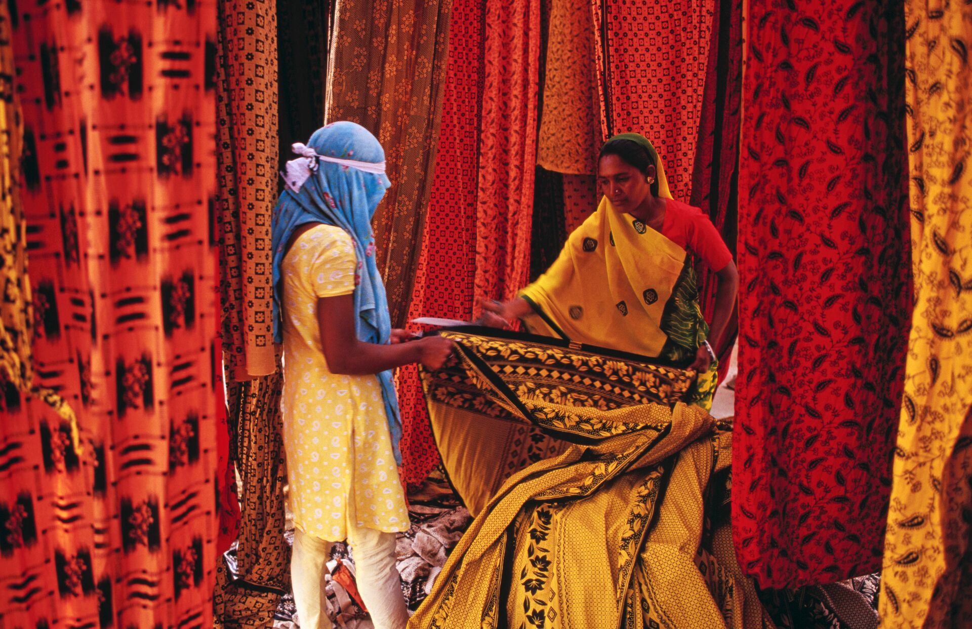 Indian woman selling printed material