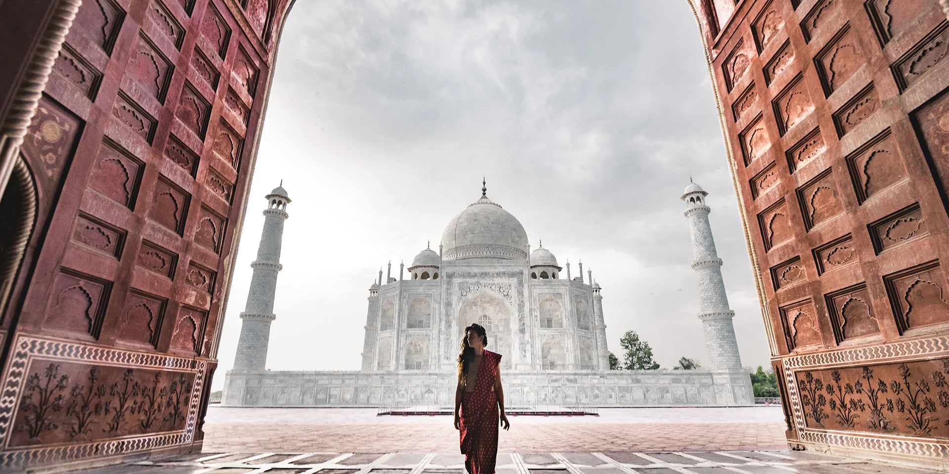 Scenic view of a person walking in front of the Taj Mahal in Agra, India