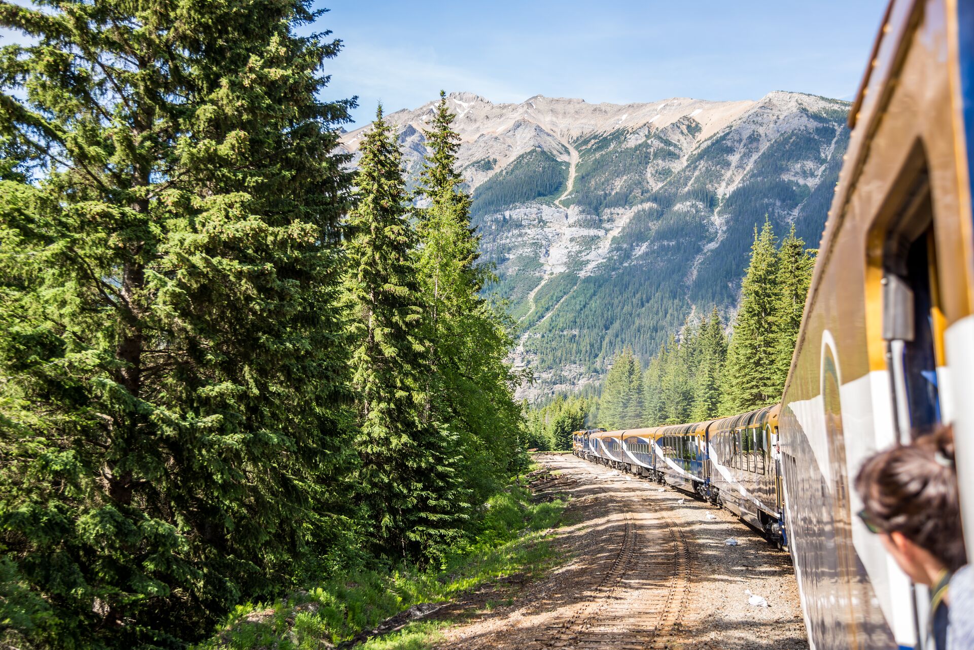 Woman looking at the mountains while riding the Rocky Mountaineer Train in Vancouver, British Columbia Canada