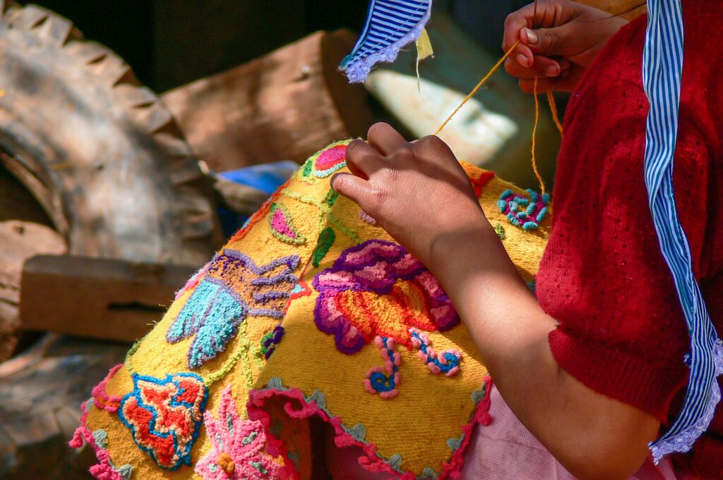 Colourful embroidery being made on a piece of fabric