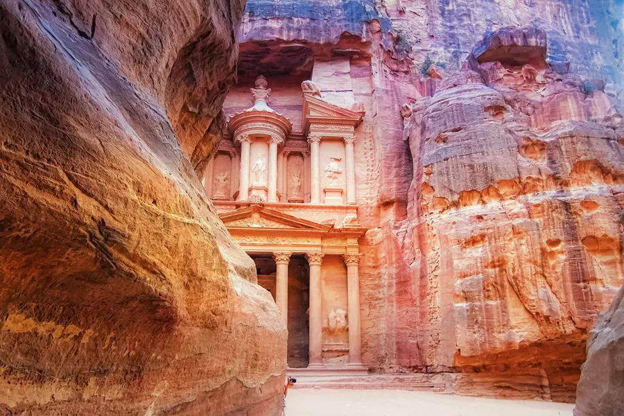 Petra partly obscured by a dramatic rock face in Jordan