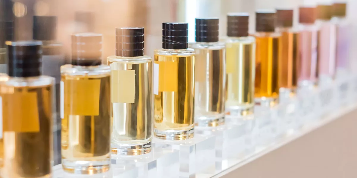 Set Of Colorful Perfume Bottles In Shop Window