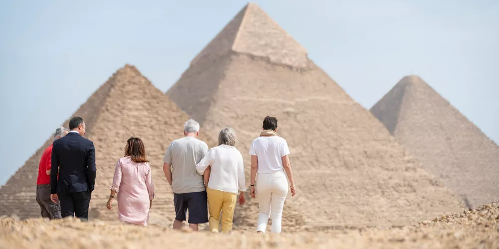 Group of tourists admiring the great pyramid of Giza near Cairo in Egypt
