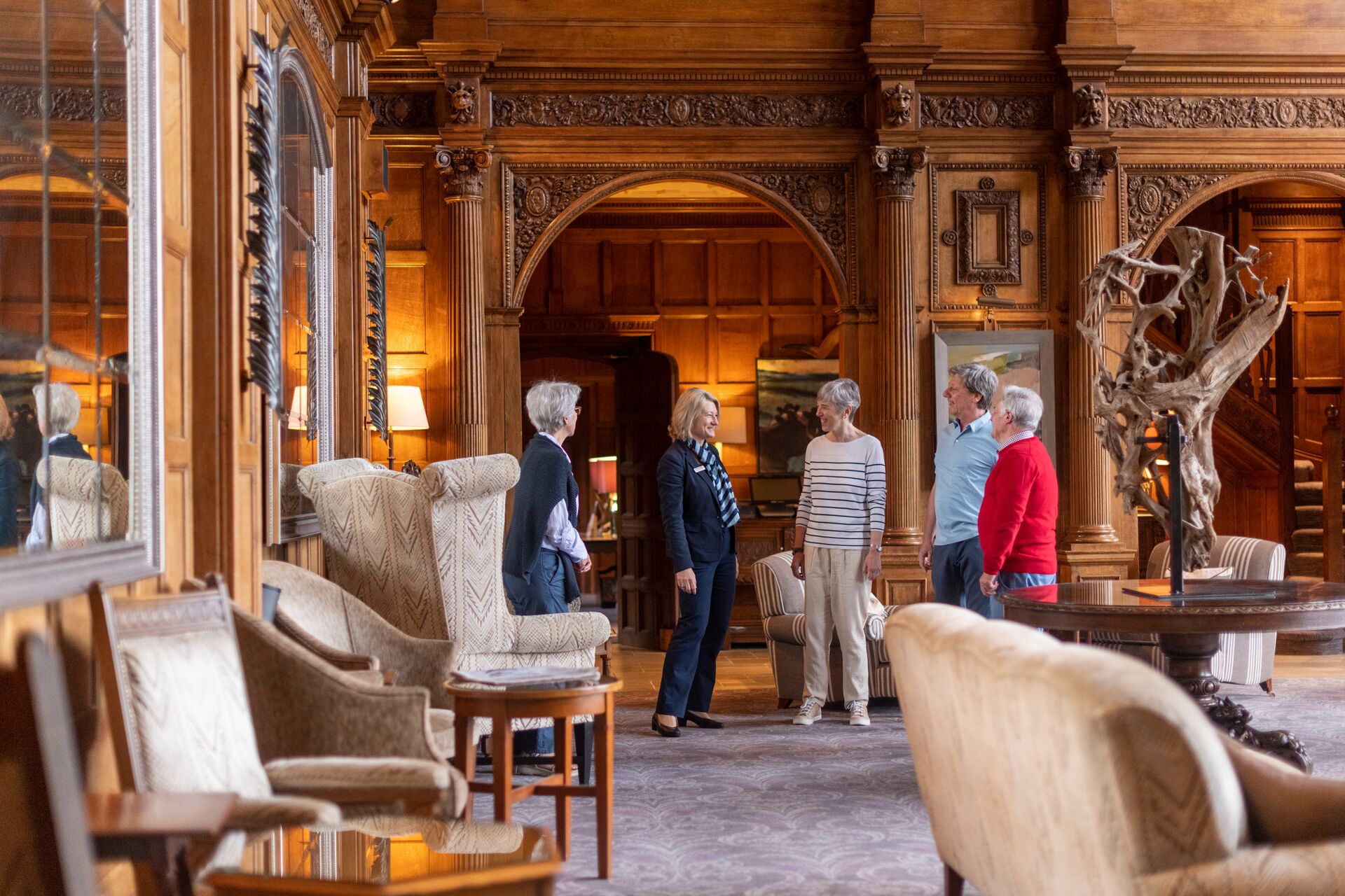 Travel director talking to tourists in Bovey Castle in Devon, England, UK