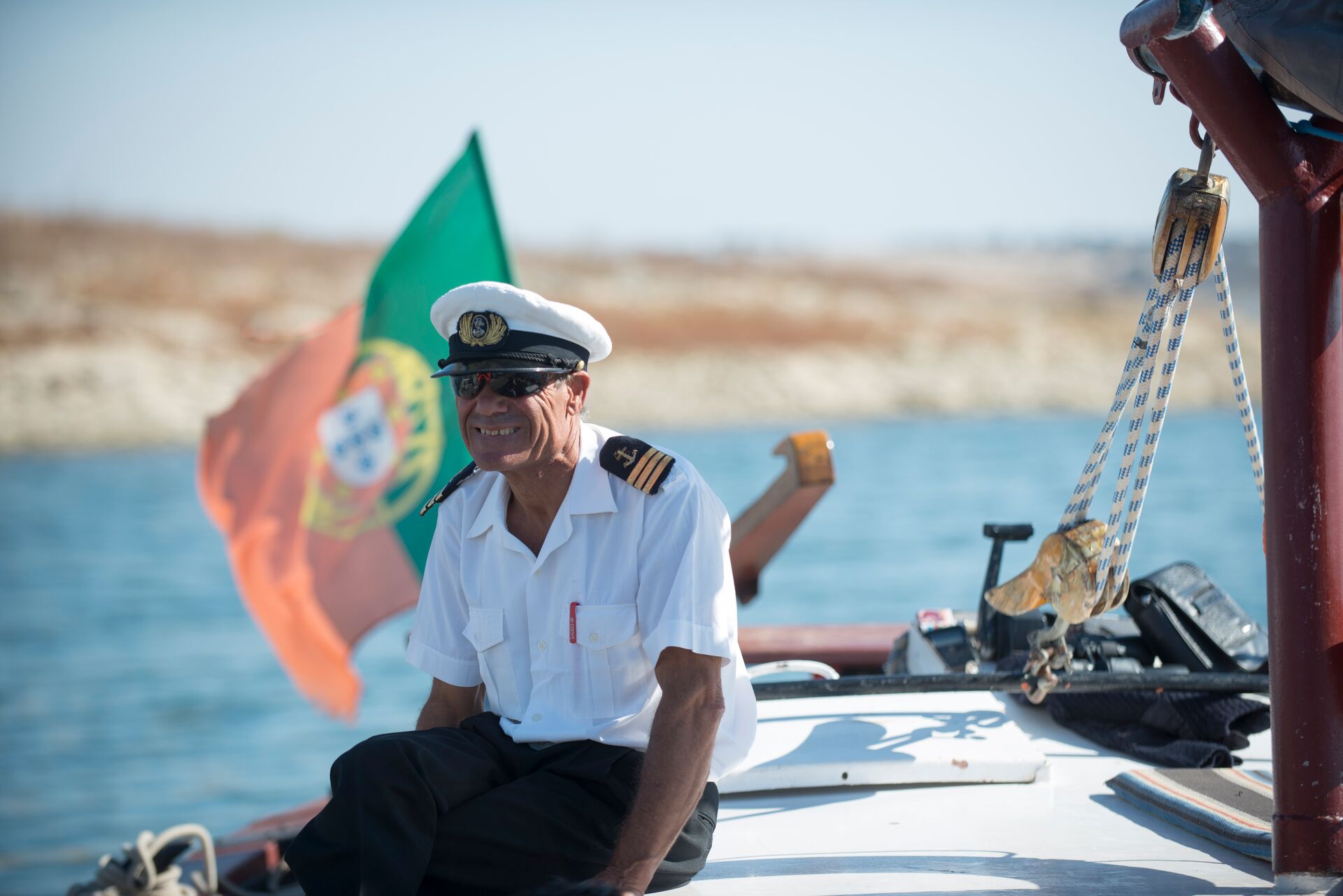 Captain smiling while sitting on his boat in Portugal