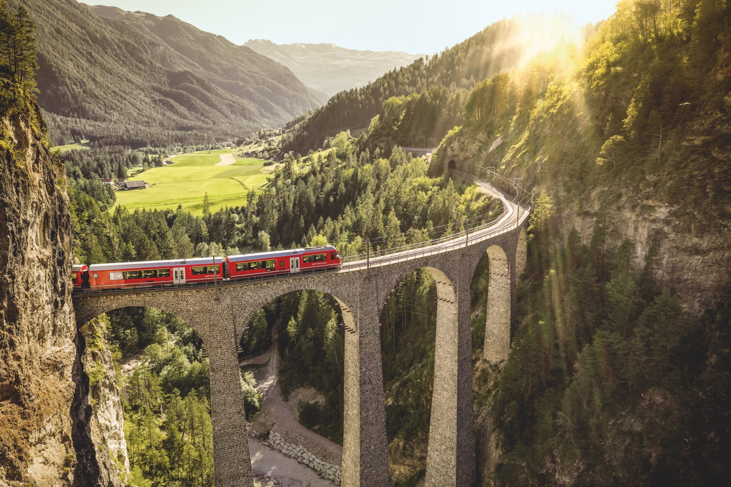 Swisstainable Grand Tour train passing over viaduct