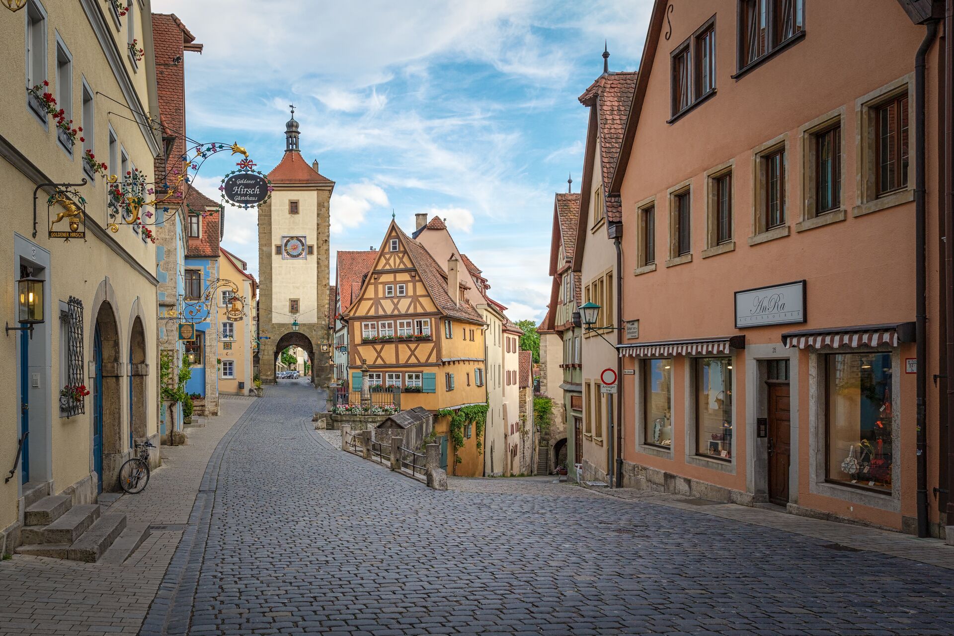 Medieval timber houses flank a cobbled street in Rothenburg-ob-der-Tauber in Germany