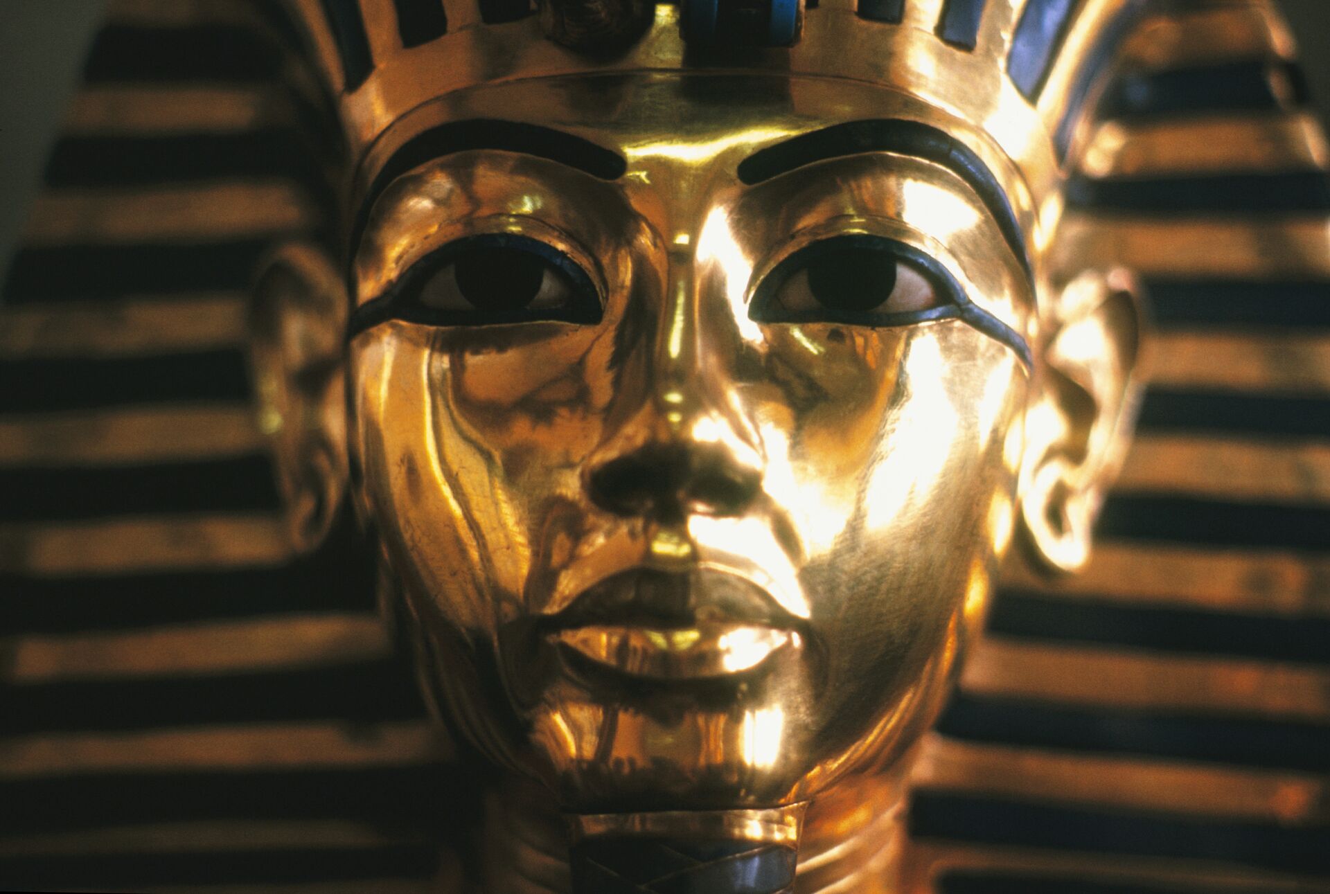Close up image of King Tutankhamen’s gold mask, with blue details