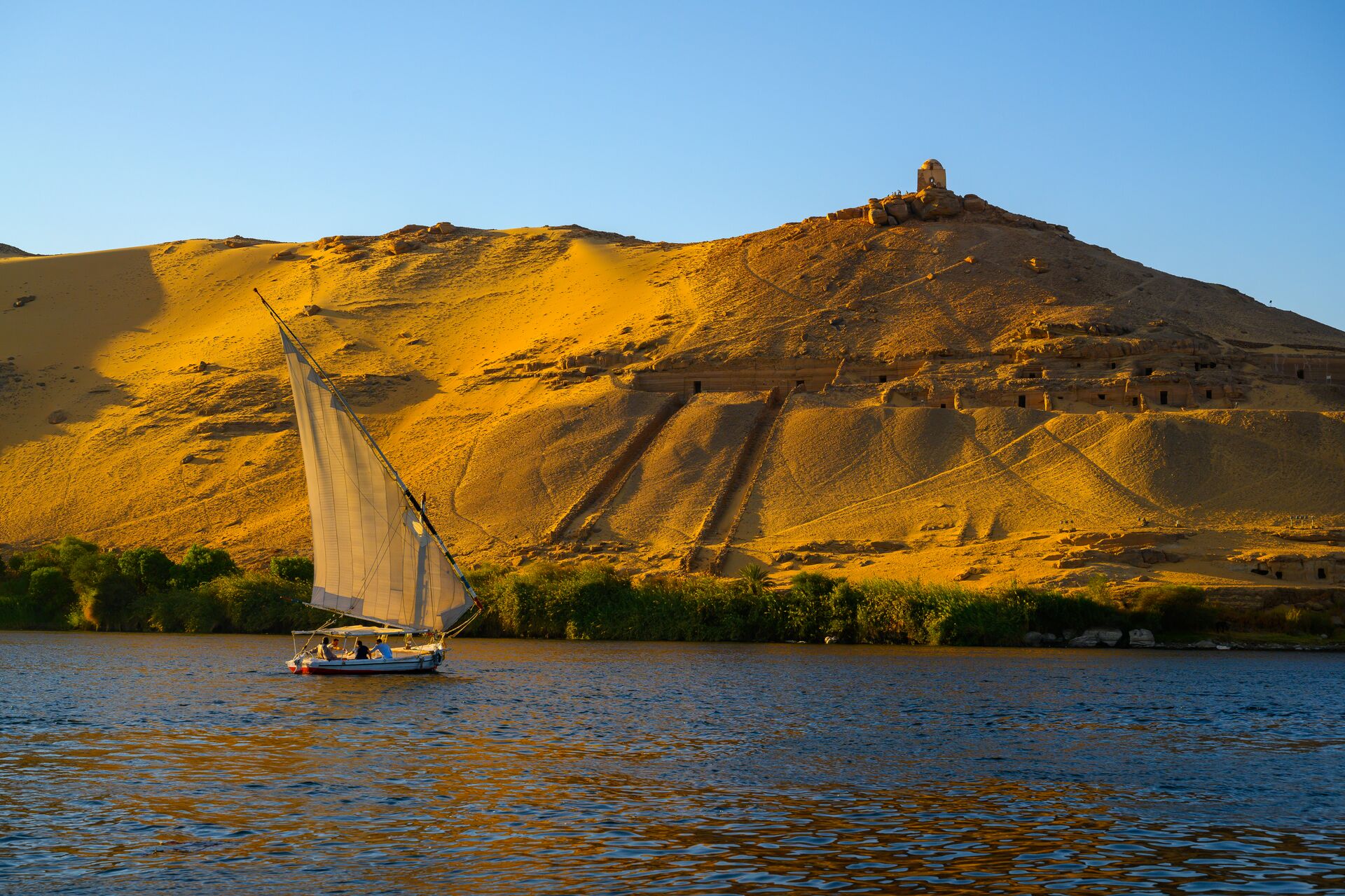 Image of sunset scene of boat on the river nile