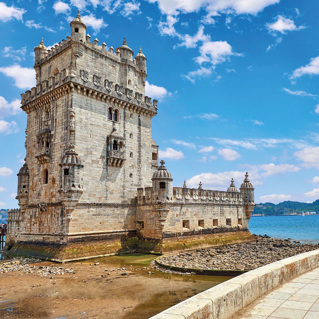 An old Portuguese castle stands over the sea
