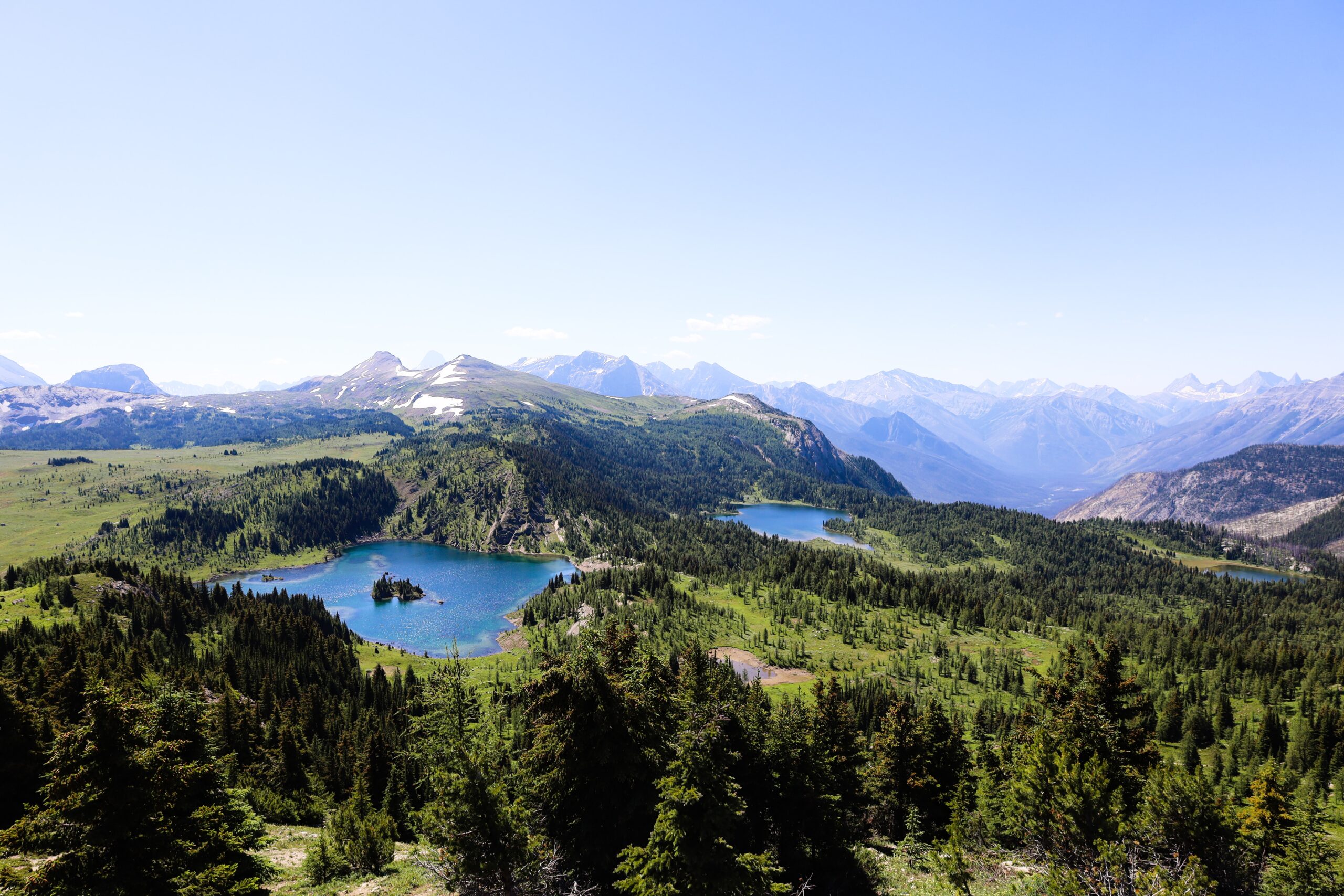 Ariel shot of the bright blue lakes and dense boreal forest of Banff Canada, the great outdoors