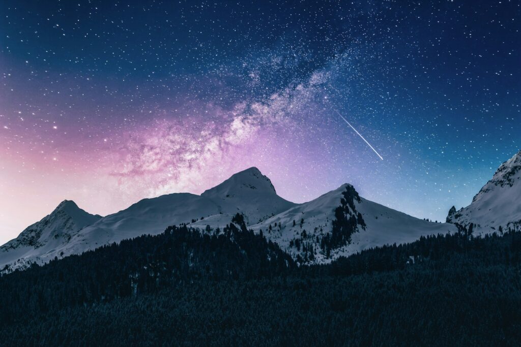 Photo of the Milky Way galaxy over the peaks of mountains