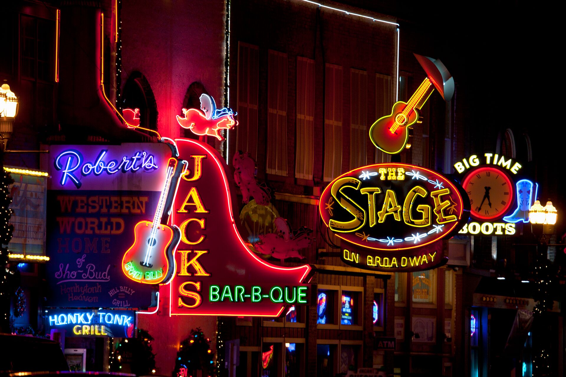 Bright neon coloured signs decorate shop fronts on Broadway in Nashville