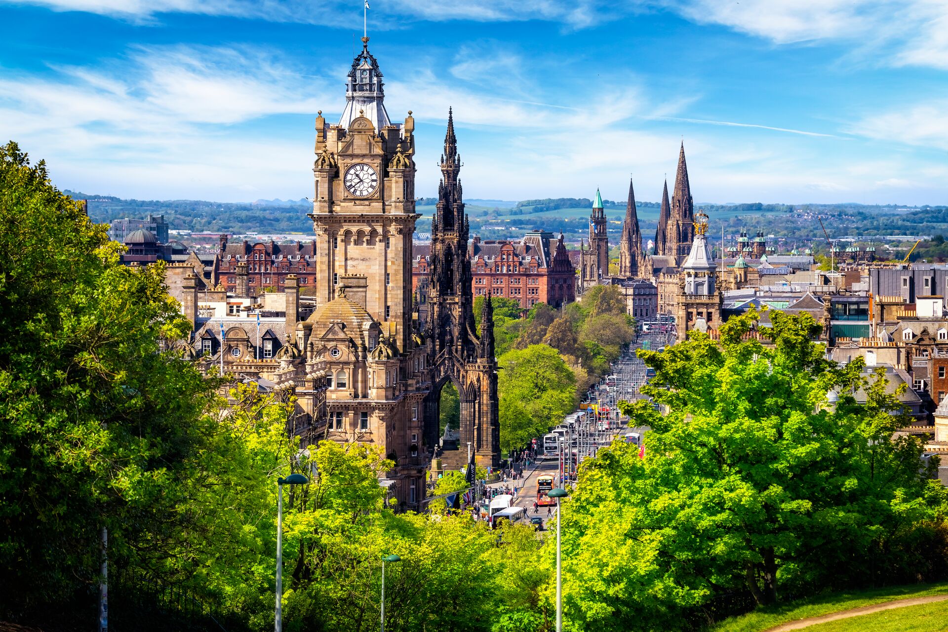 Edinburgh Cathedral is shown from an Ariel shot surrounded by green trees and bustling streets