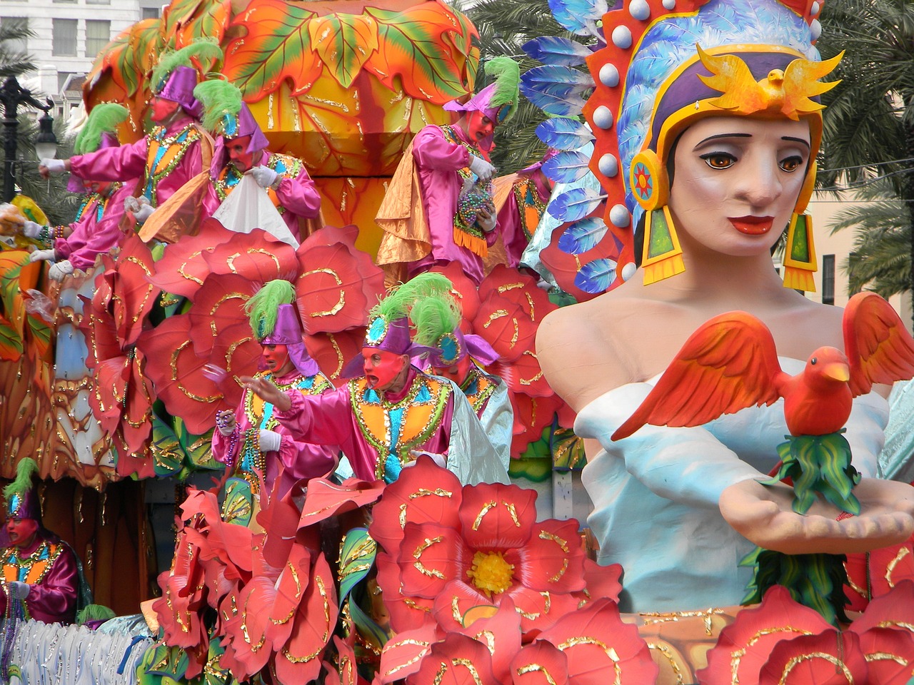 Bright red, yellow and blue decorations and figures sit on a Mardi Gras bloat