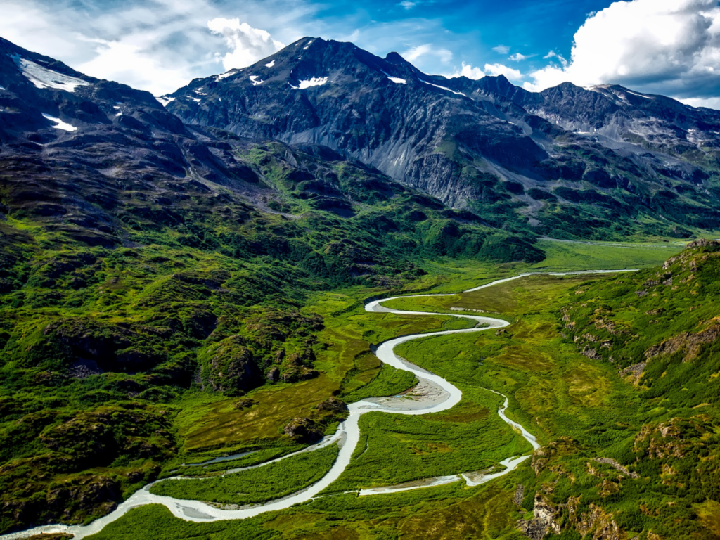 Birds-eye view of Alaskan landscape - forests and wilderness carved by a winding river