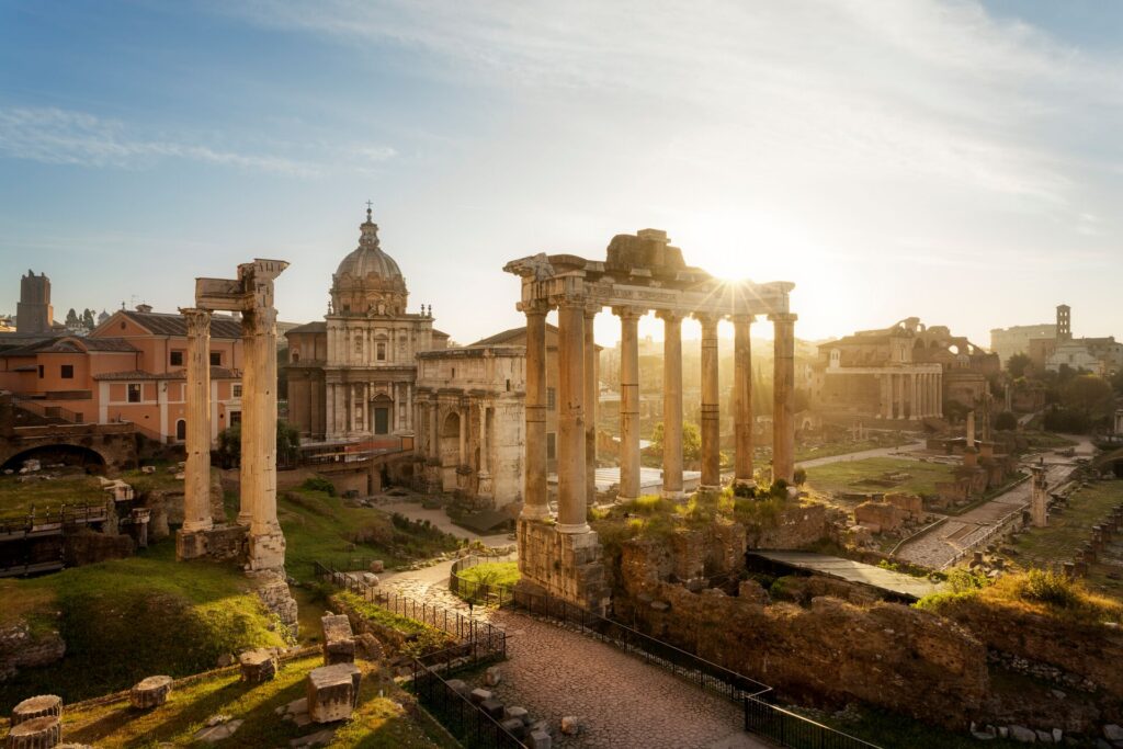 The Roman Forum, a stunning display of the architecture of Rome, bathed in the warm hues of sunset in Italy's capital.