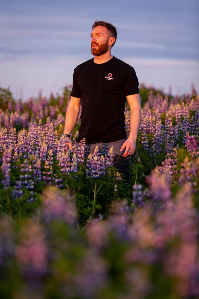 A picture of Michele, one of our global travel experts, standing in a field of lavender looking off-camera into the distance