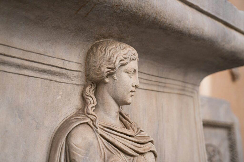 carved stone female face on a pillar or fountain in Rome