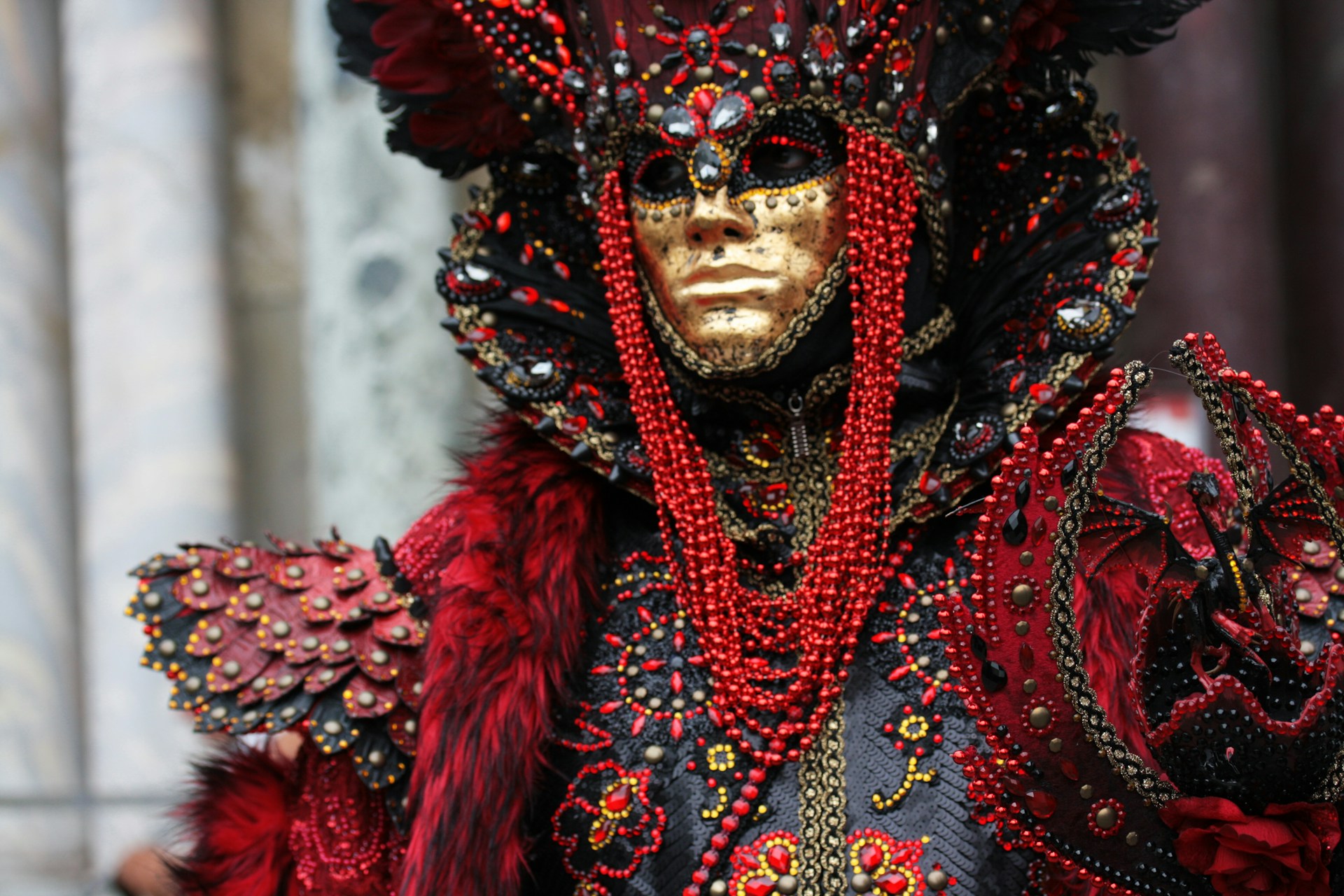 Close up of person wearing an elaborate costume and mask for Venice Carnevale