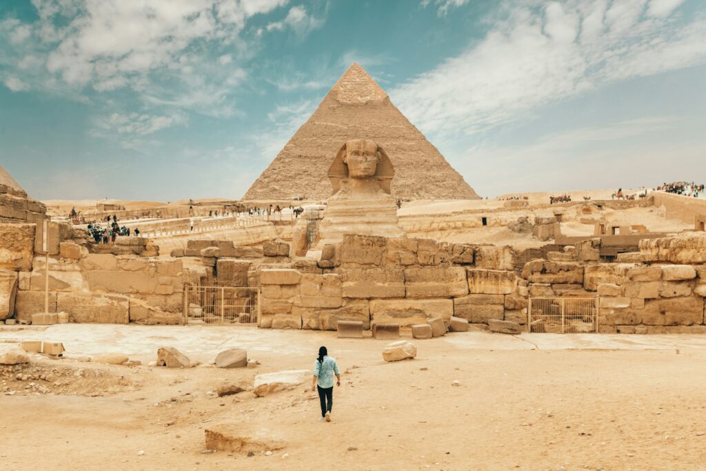 The Sphinx sits in front of the Great Pyramid of Giza