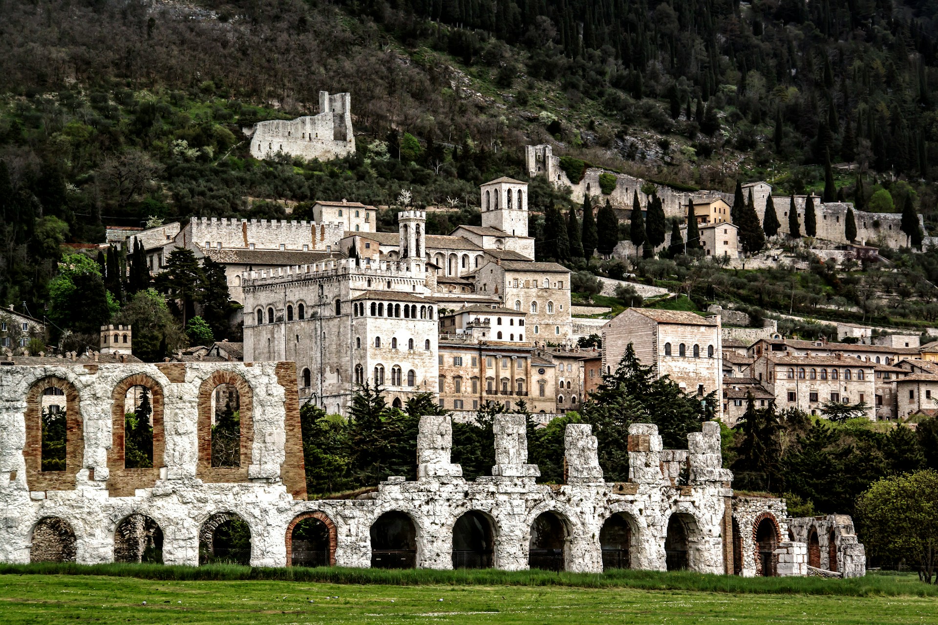 Photo of the town of Gubbio, Umbria, with the roman theatre in the foreground and the rest of the town stretching up the hill in the background