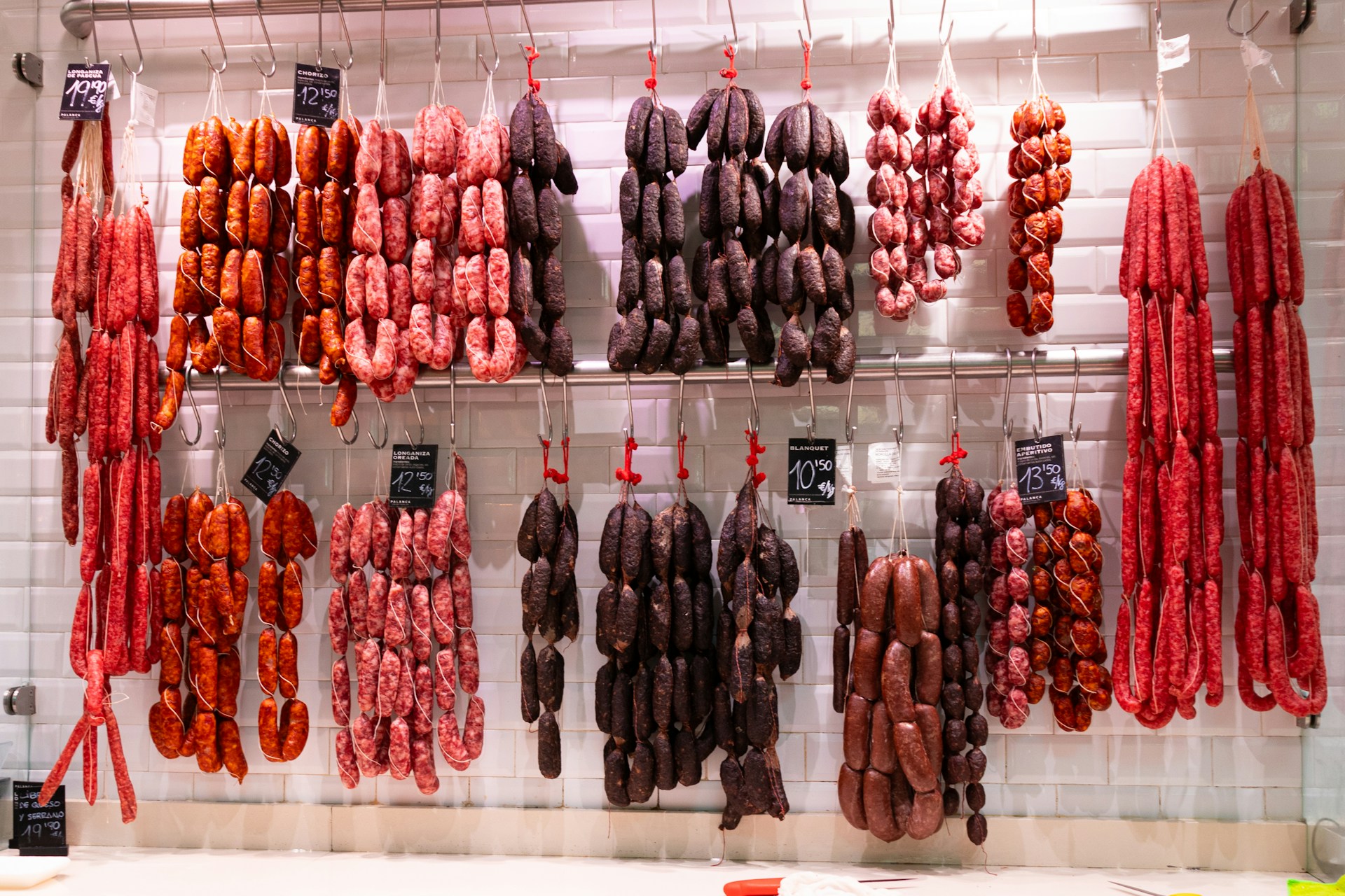 Strings of chorizo and other sausages hanging in a Spanish butcher's shop 