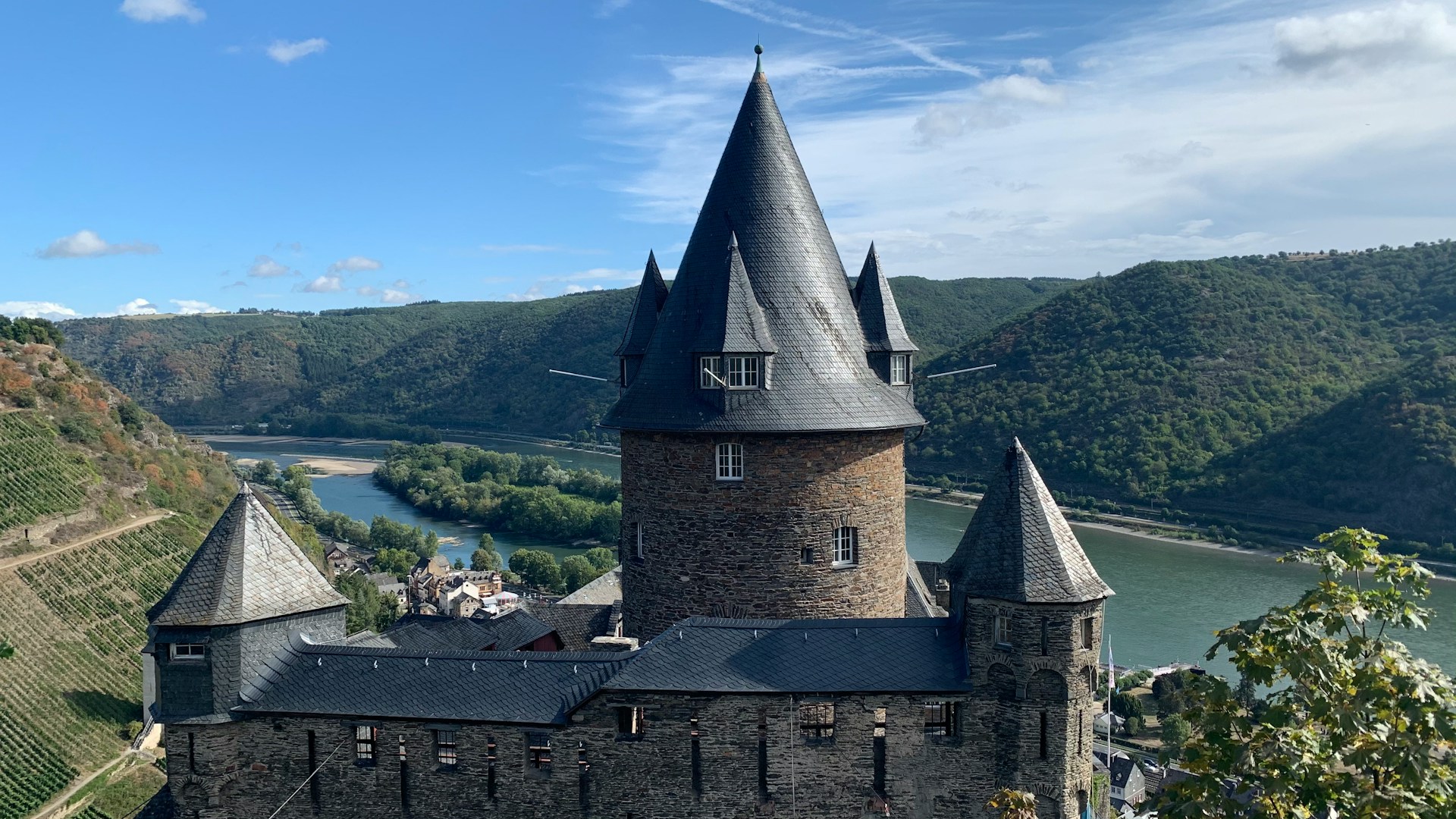 View of Stahleck Castle in Bacharach, with the Rhine Valley and step-sided vineyards in the background