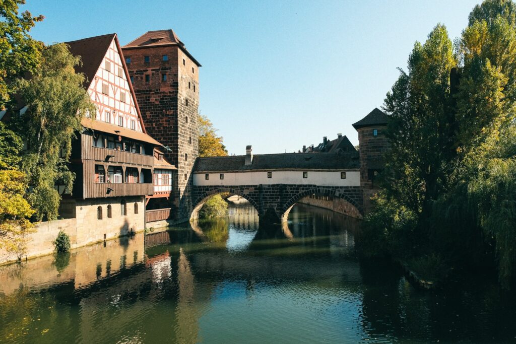 An image of the Pegnitz River, a medieval bridge and watertower it flows beneath
