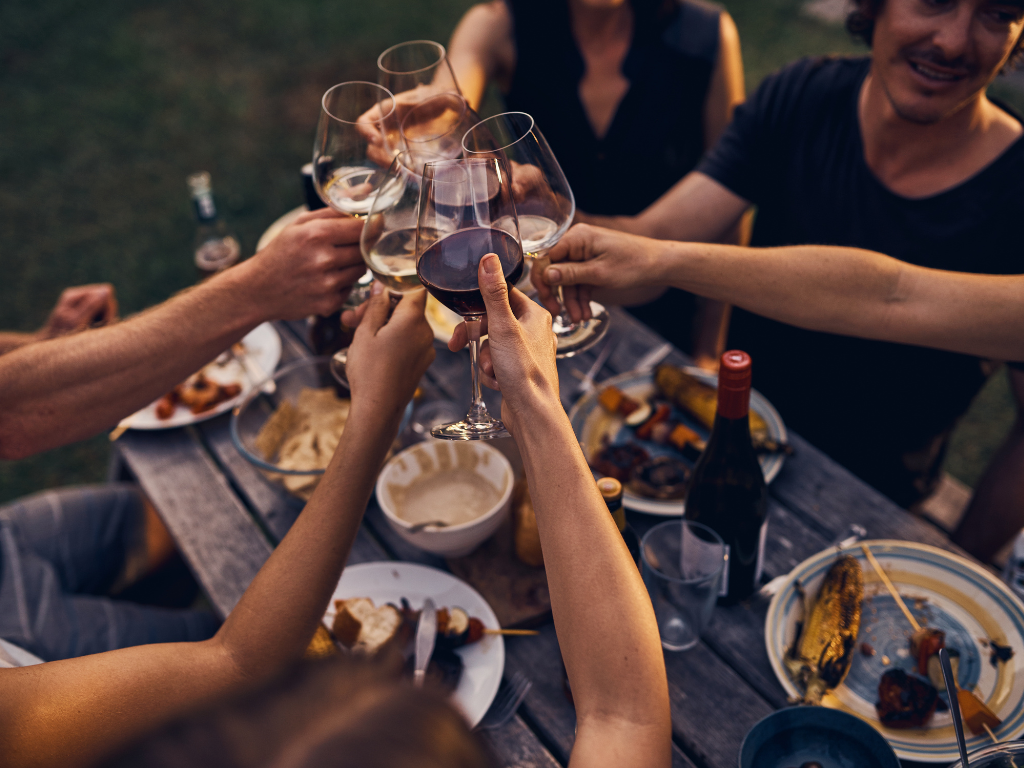 table clinking glasses of wine