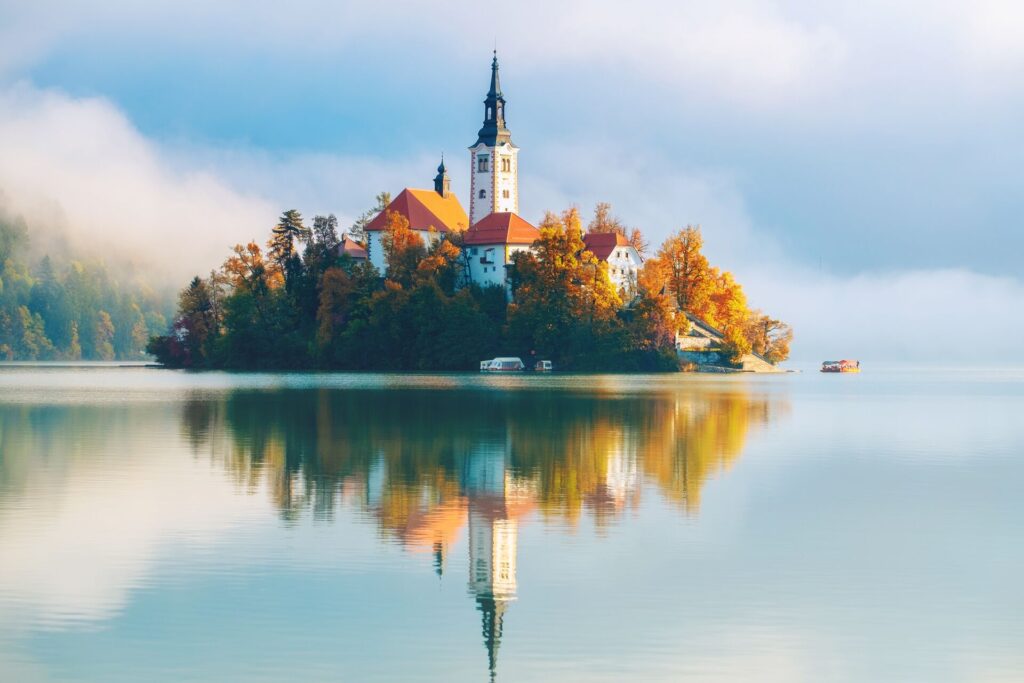 Tall tower on a small island in the middle of Lake Bed, Slovenia