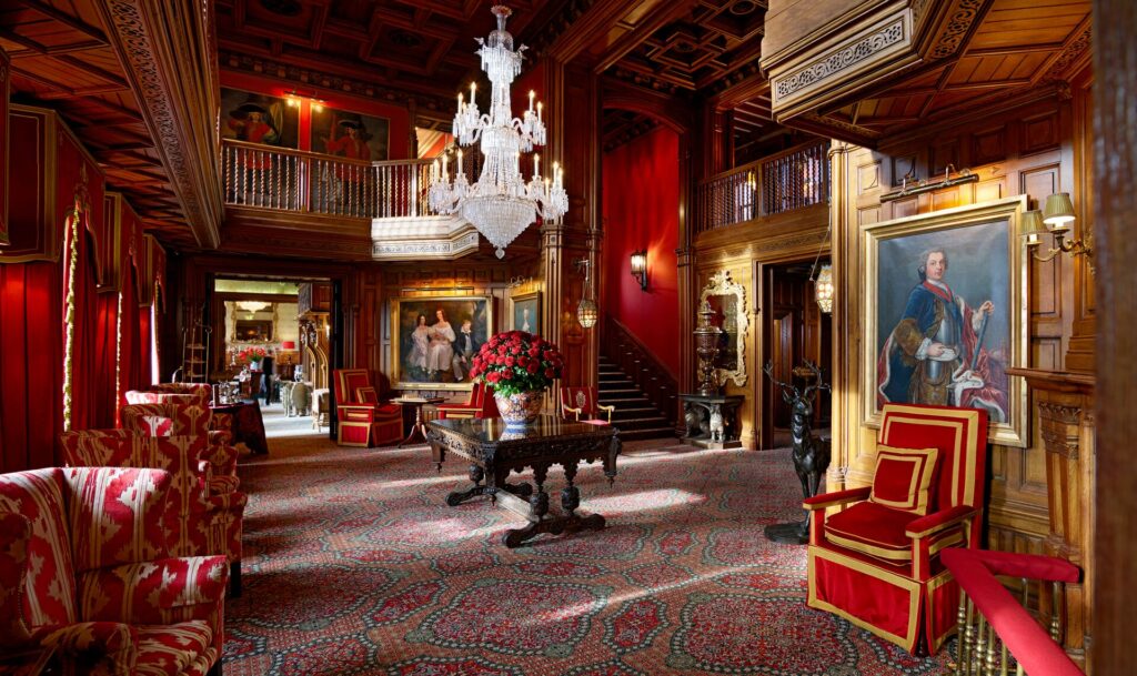 Plush red furnishings in the entrance Hal of Ashford Castle in Ireland