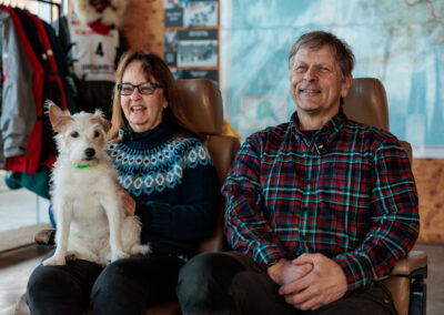 Martin Buser at next to his wife with a small dog on her lap