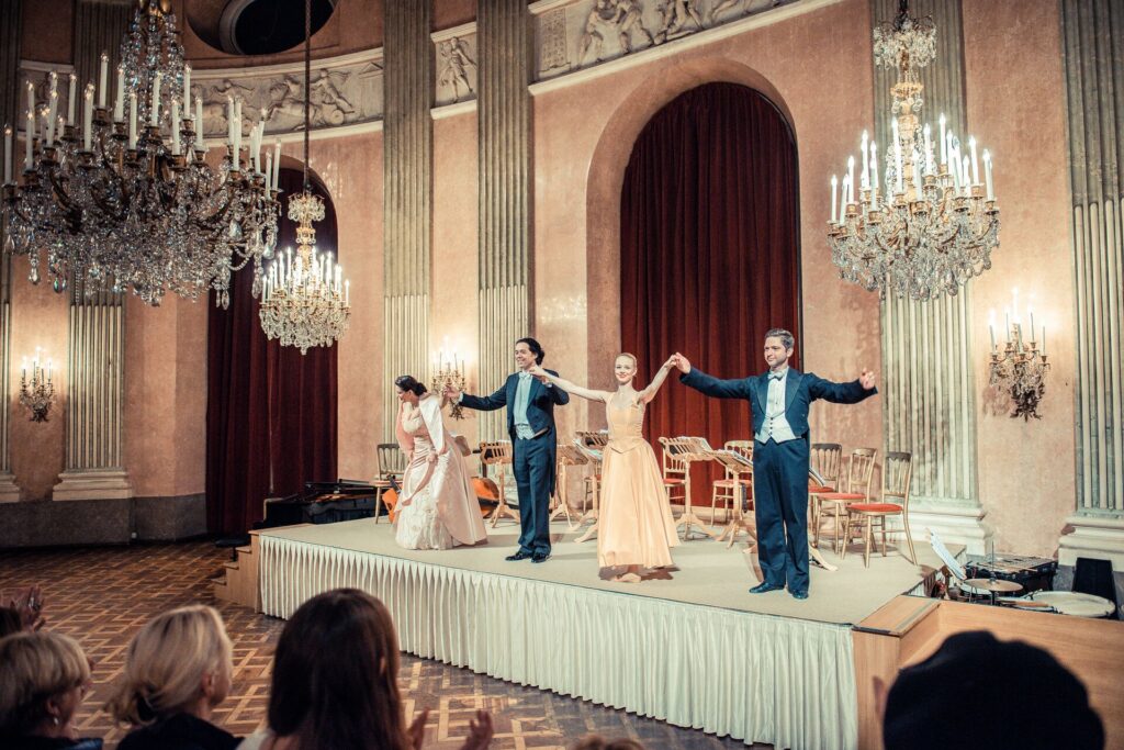 Four singers bow on stage following a concert in Vienna, Austria