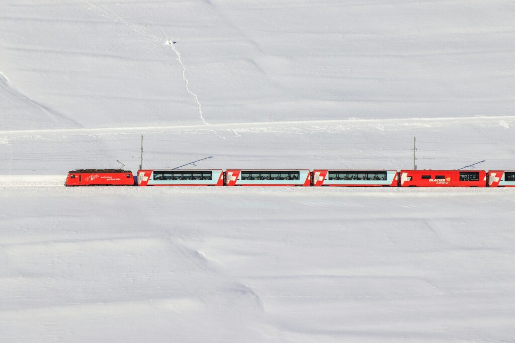 Glacier express train traveling through snowy landscape