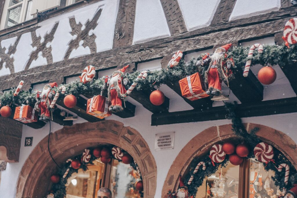 Christmas garlands strung along a medieval shop front