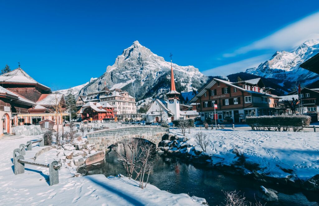Swiss mountain village with mountain peaks in the background